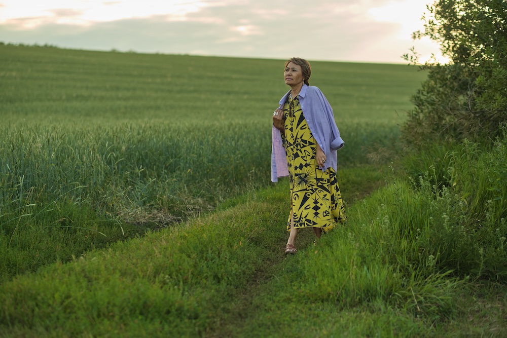 Woman walking in field who is learning how To Recover From An Eating Disorder.