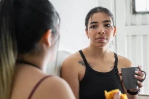 Women wondering "why do i feel guilty after eating", a common concern in unhealthy relationships with food.