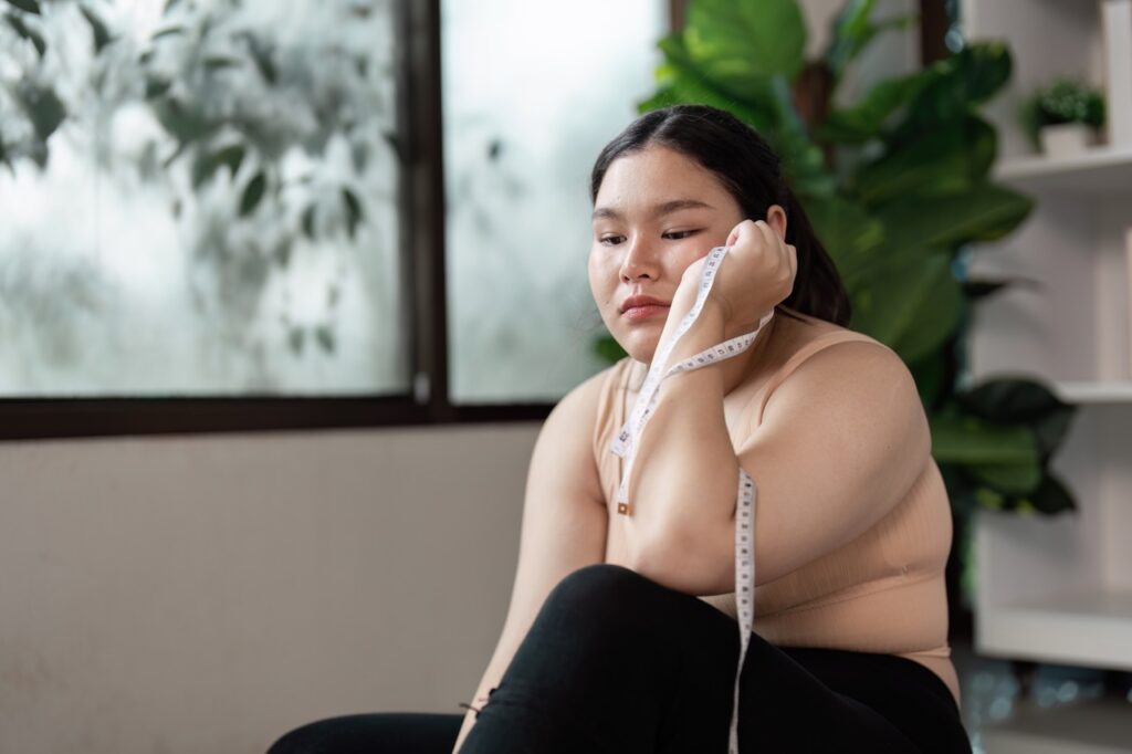 Woman thinking about weight gain in bulimia recovery.