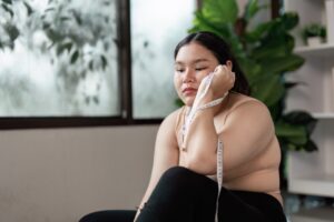 Woman thinking about weight gain in bulimia recovery.