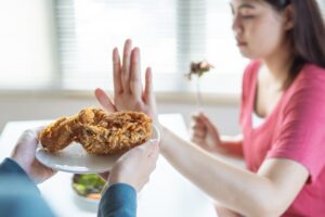 Woman at We Conquer Together thinking What is food aversion.