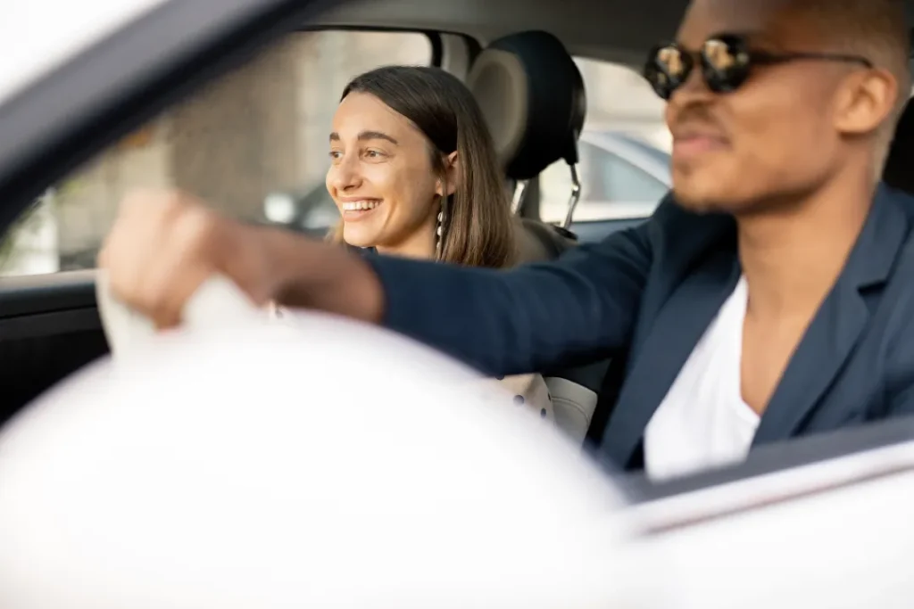 happy woman and man riding in a car - Mental Health Treatment Orange County | We Conquer Together