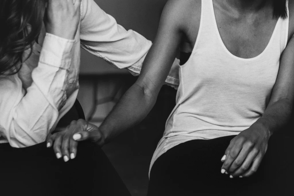 women helping friend with alcohol problems and an eating disorder.